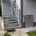 Wheelchair lift in front of steel stairs