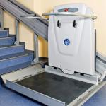 ThyssenKrupp wheelchair lift in front of straight staircase